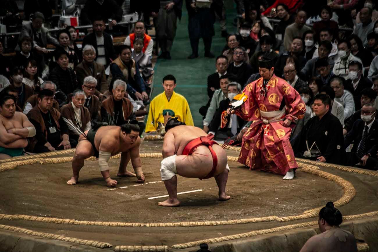 Both sumo wrestler must put both fists on the ground to start the match. Photo source: James Saunders-Wyndham