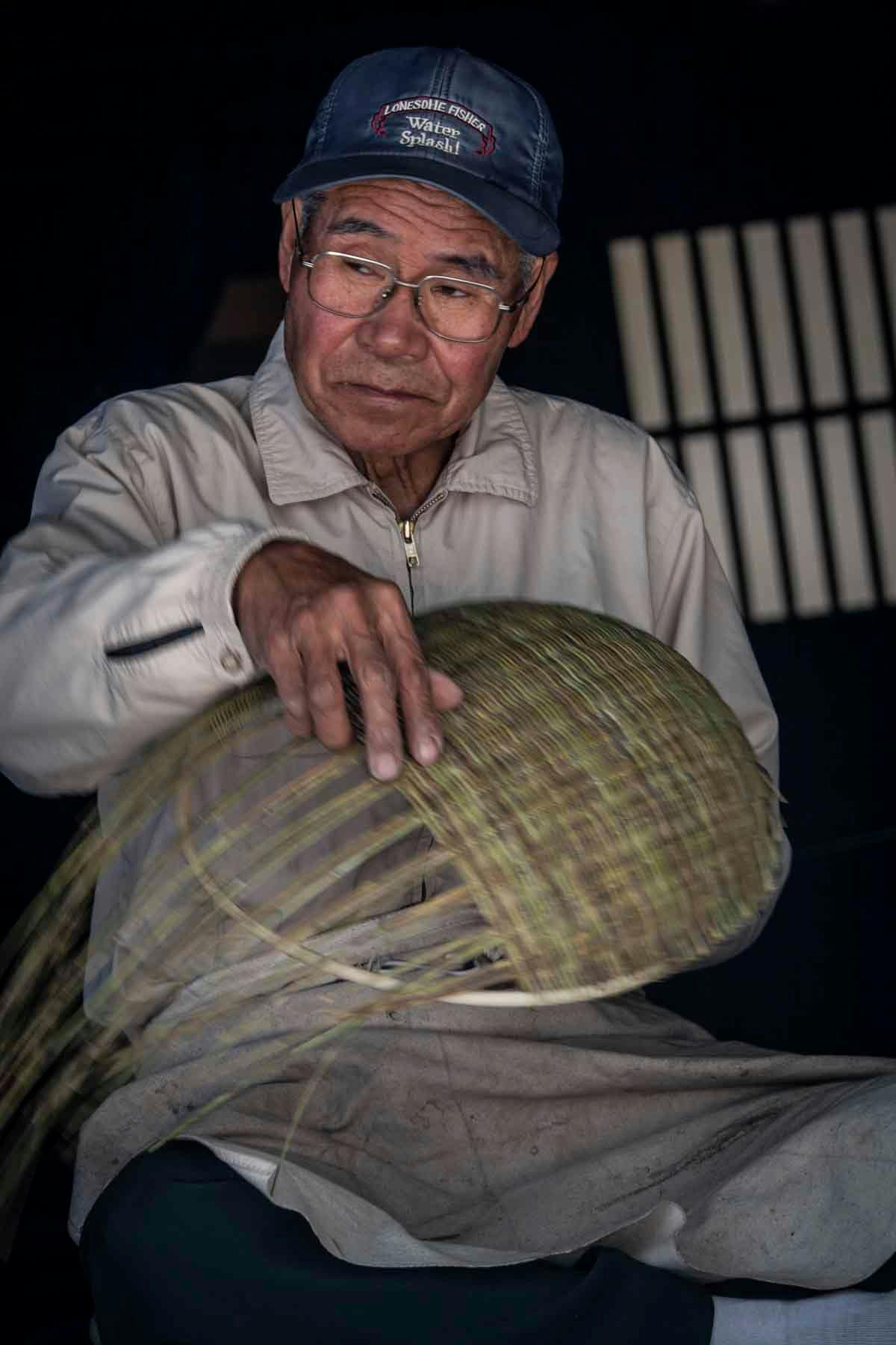 Older Japanese man weaving baskets in Takayama, Japan. Photo source: James Saunders-Wyndham