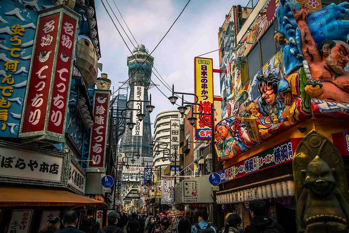 A view of some restaurants in Shinsekai and the Tsutenkaku Tower. Photo source: James Saunders-Wyndham