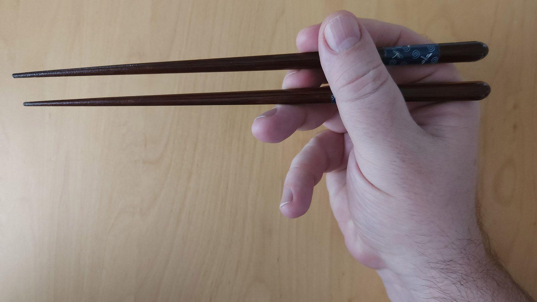 This is the correct way to hold your chopsticks. In Japan, people hold their chopsticks parallel with little space between. This can be hard to do at first, but the muscles in your hand will get used to it. Photo source: James Saunders-Wyndham